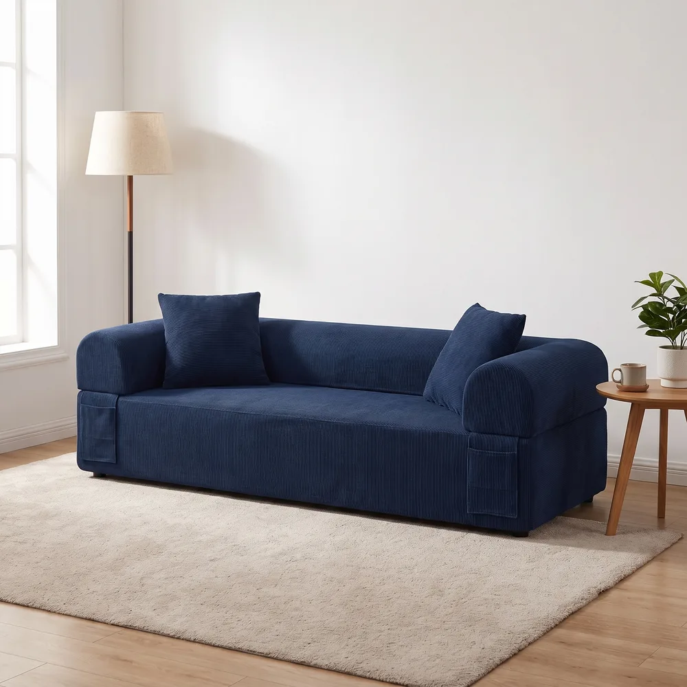 Navy boneless daybed sofa in a bright living room with a beige rug and a floor lamp