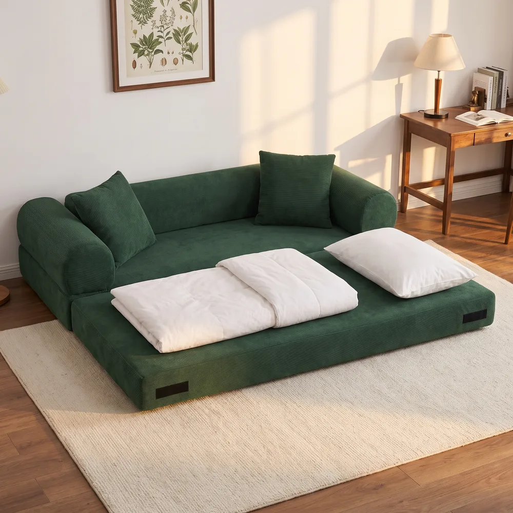 Green boneless sofa bed pulled out into a floor bed with a white duvet and pillow in a guest room