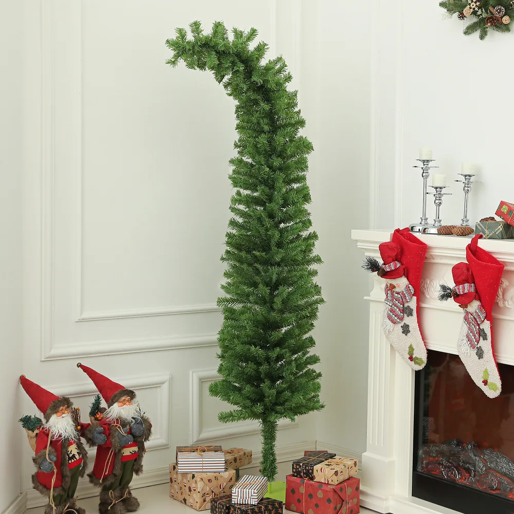 Whimsical bent-top Christmas tree next to a fireplace with stockings